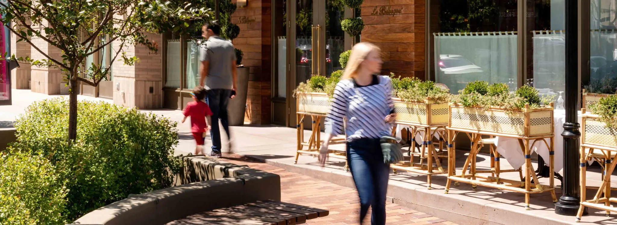 People walking down sidewalk
