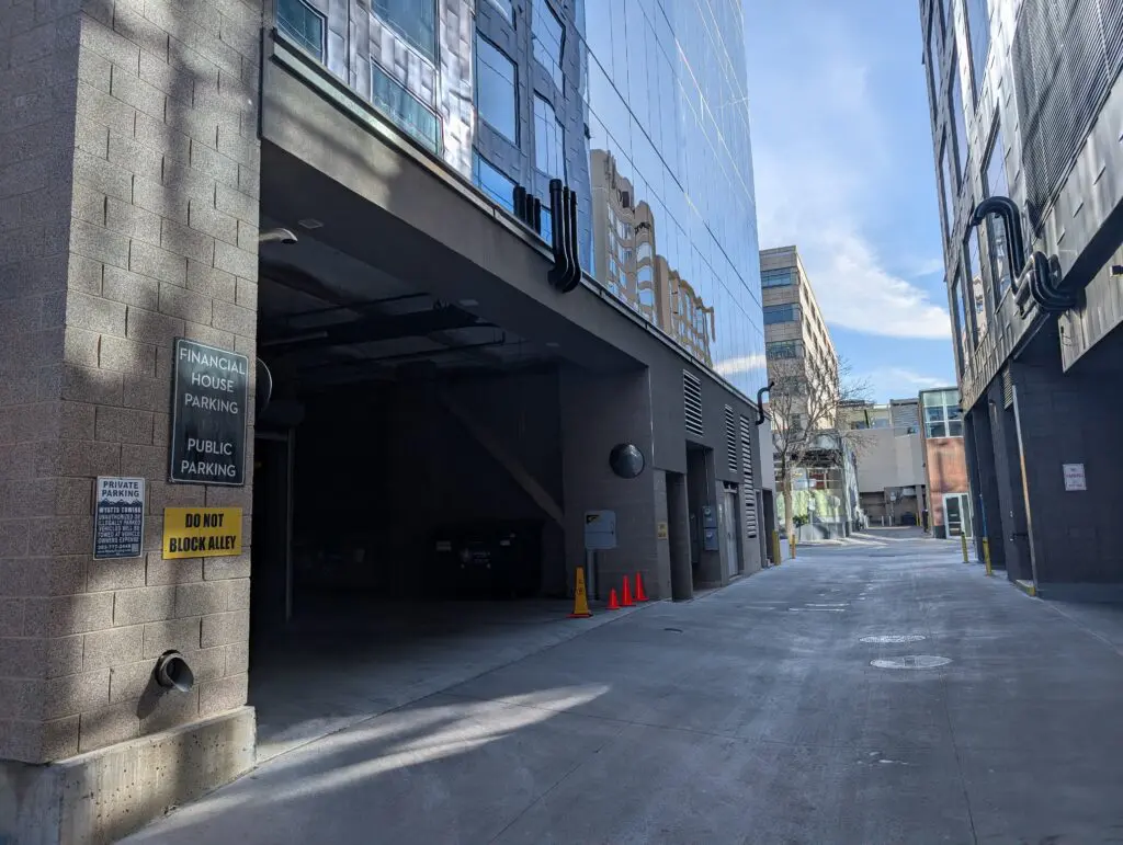 Financial House parking alley with signs: "Public Parking," "Do Not Block Alley.
