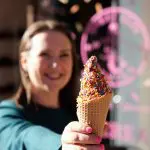 Woman holding ice cream cone with sprinkles in Cherry Creek North. Mother-daughter girls day.