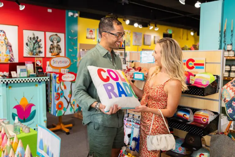 A man showing a decorative pillow to a woman
