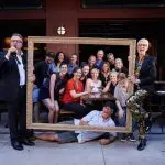 Brand refresh photo shoot: Group poses in a gold picture frame.
