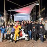 Holiday commercial behind-the-scenes group photo with scooter.