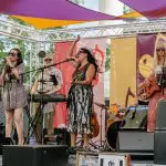 Band performing on stage at the 2025 In Bloom event.