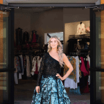 Woman in gown at Cherry Creek North boutique entrance.