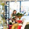 Woman shopping for holiday decor in a small business shop window.