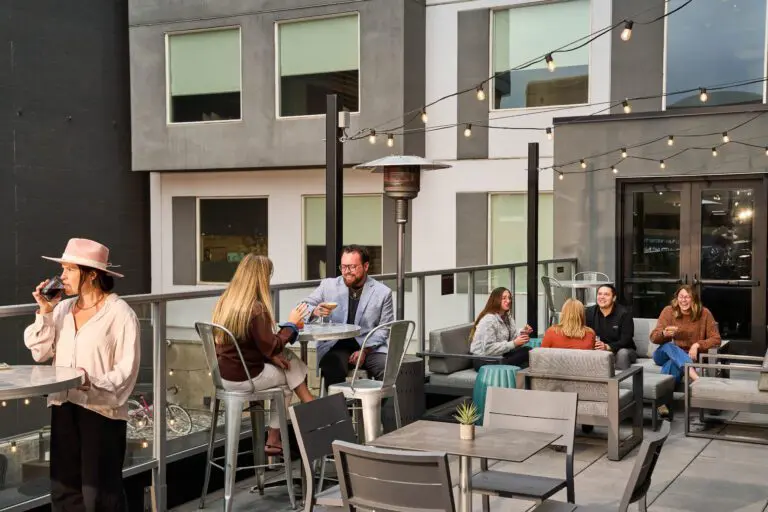 People socializing on a boutique hotel's outdoor patio.
