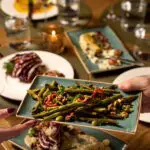 Image of food being passed to hands