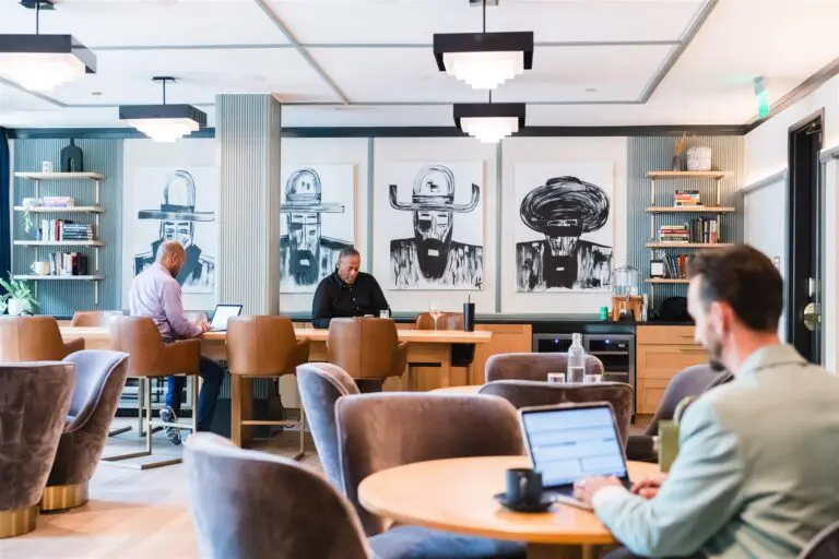 People working in a modern office space with unique artwork.