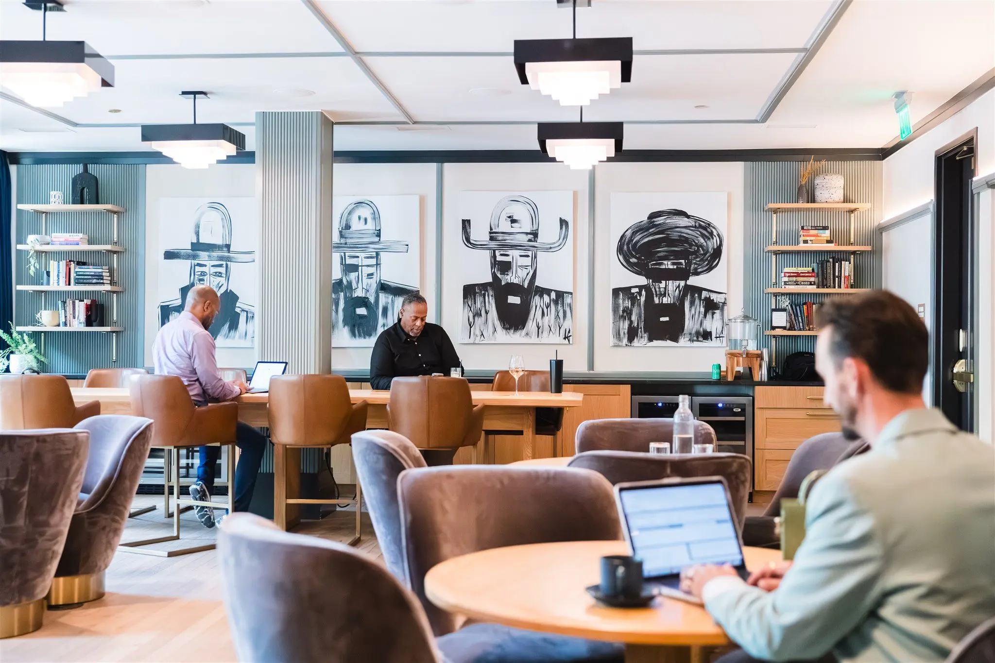 People working in a modern office space with unique artwork.