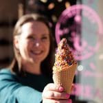 Woman holding ice cream cone with sprinkles in Cherry Creek North. Mother-daughter girls day.