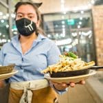 Waitress serving fries and soup at a restaurant. CCN 5 Star Certified service.