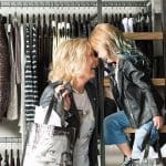 Mother and daughter in A Line Boutique closet, heads touching.