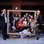 Brand refresh photo shoot: Group poses in a gold picture frame.