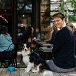 Man and dog enjoying a cafe patio. Paw-tastic shopping route!