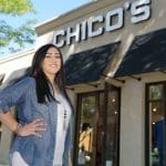 Woman stands in front of a Chico's store.