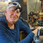 Jeweler at work in Object Design Studio, wearing magnifying visor.