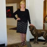 Woman poses with dog sculpture at Saks Galleries.