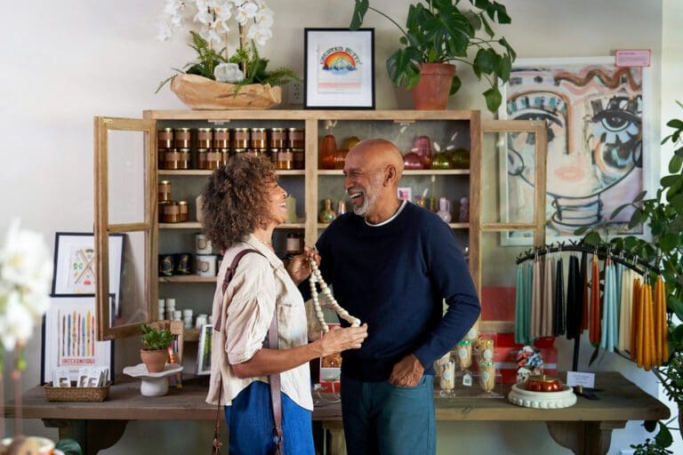 Happy couple shopping for wedding decorations in a boutique shop.