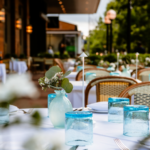 Elegant outdoor dining setup for Mother's Day Sunday brunch with blue glasses.