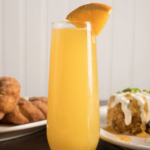 Mimosa with orange slice, breakfast dishes for Mother's Day at Syrup.