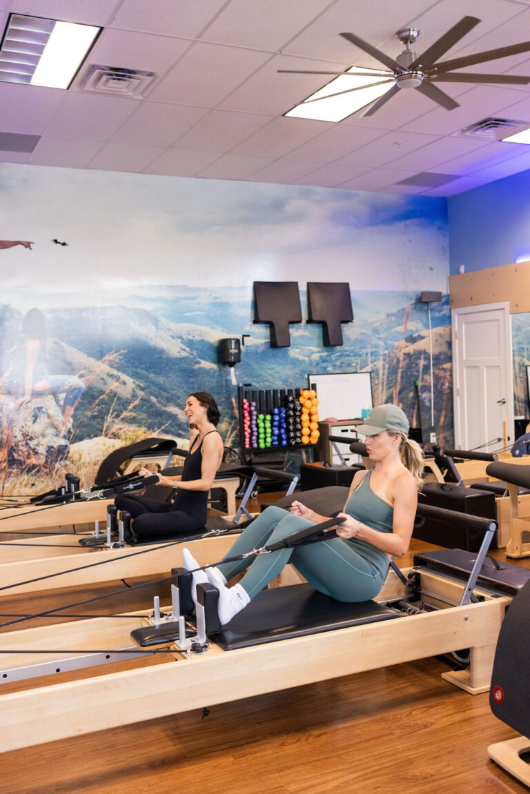 Women exercising on Pilates reformers in a Cherry Creek North studio
